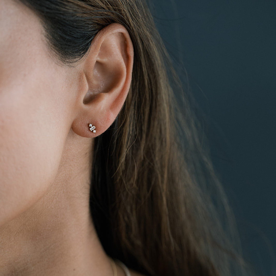 Close-up of an ear wearing a geometric CZ stud