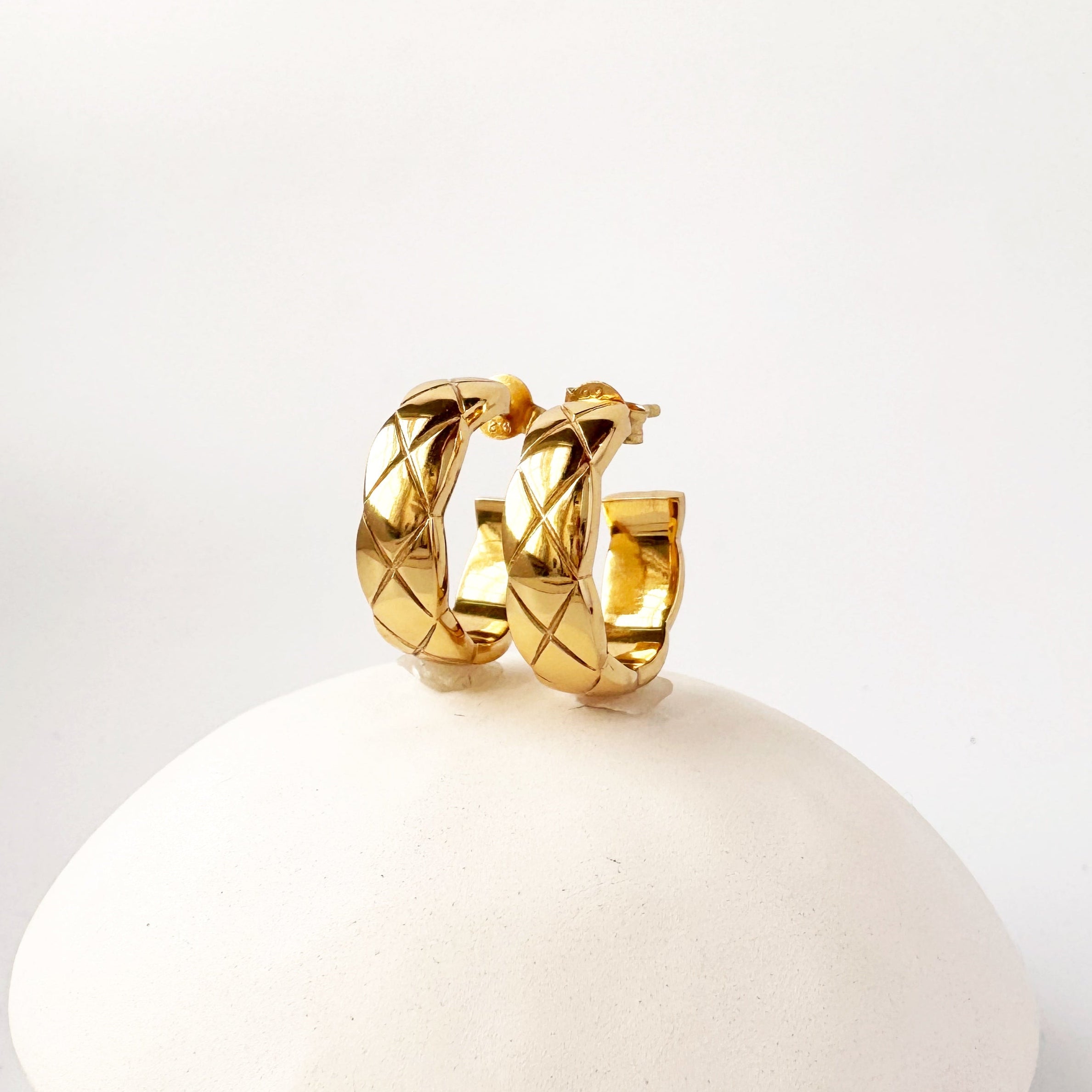 Thick gold hoops with cross hatch texture