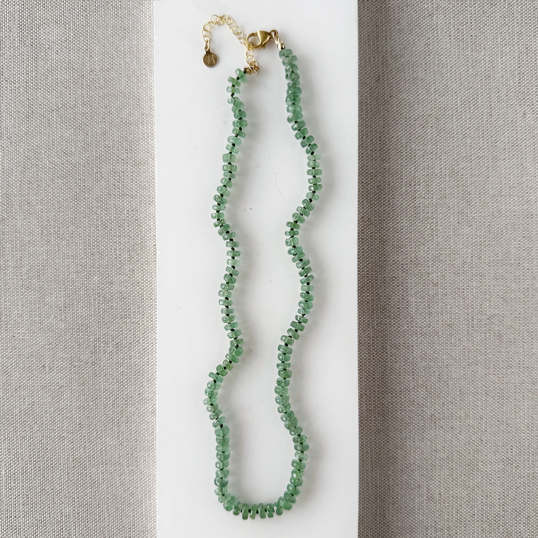 Green Kyanite knotted necklace on a white dish with a neutral background