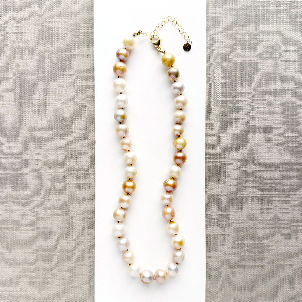 Champagne pearl knotted necklace in a white dish