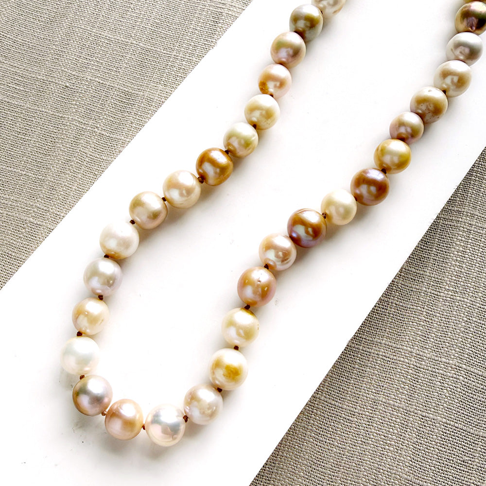 Champagne pearl knotted necklace in a white dish