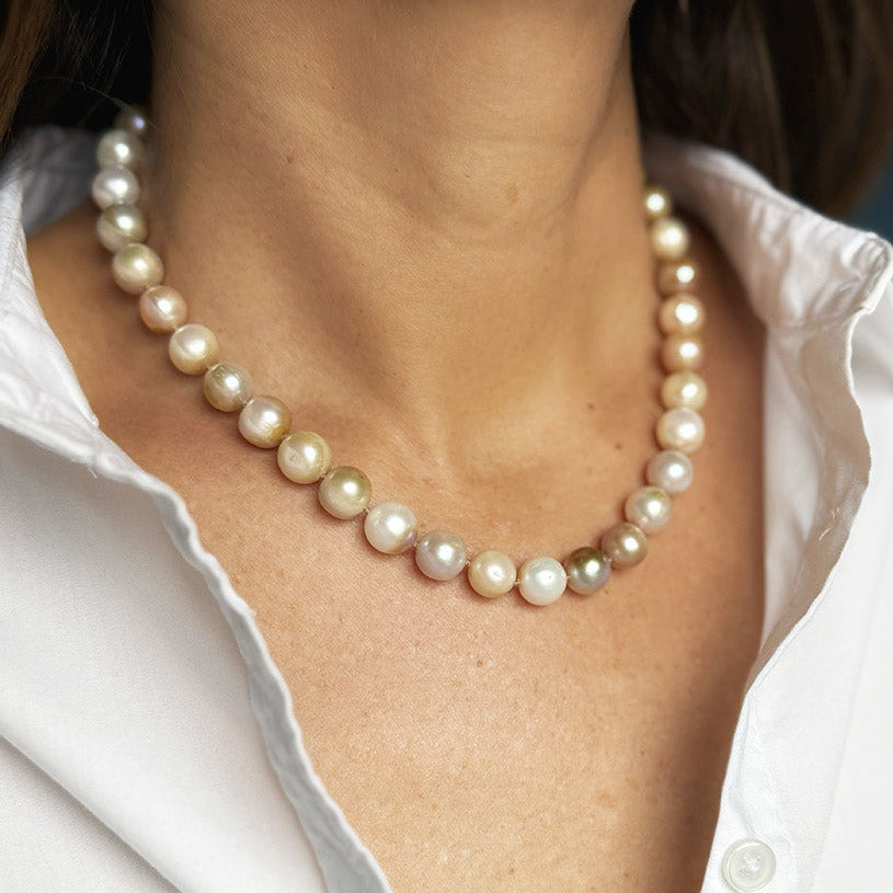 Woman wearing white shirt and a champagne pearl necklace