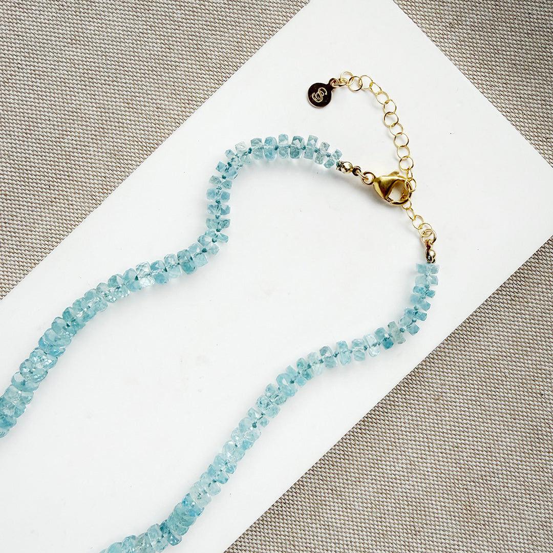 Aquamarine knotted necklace on a white card