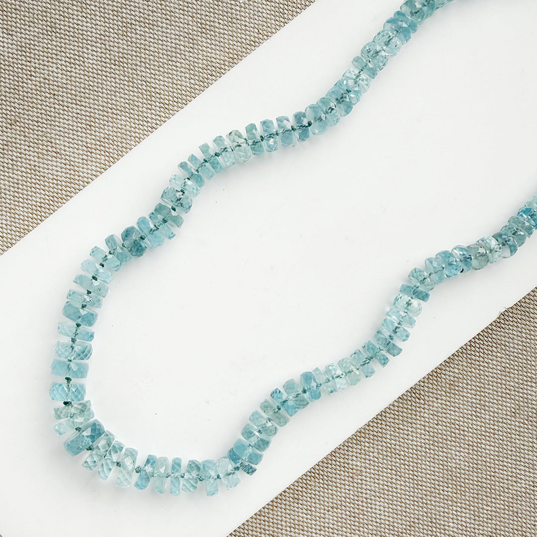 Aquamarine knotted necklace on a white card