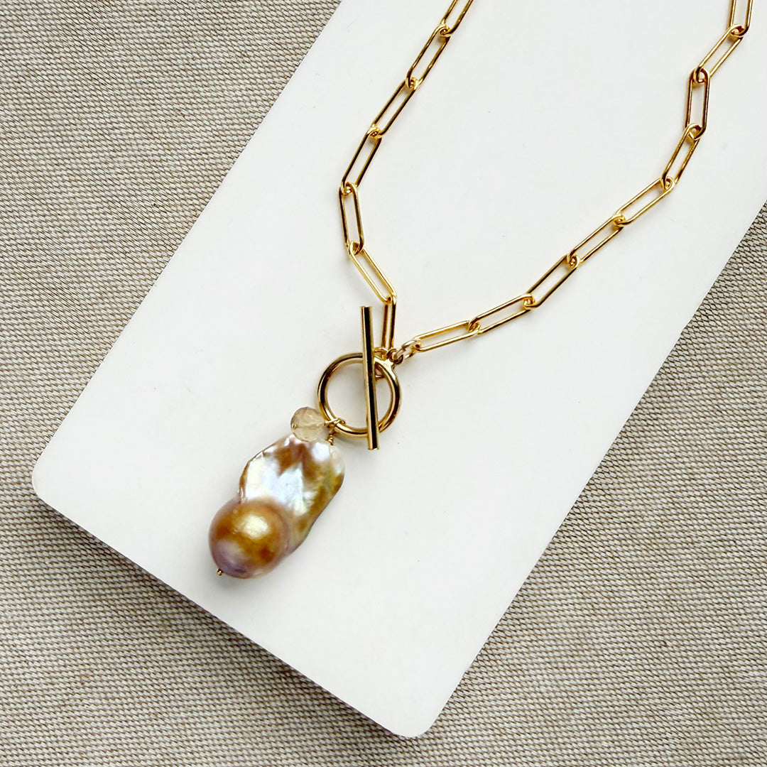 Gold necklace with large blush colored baroque pearl