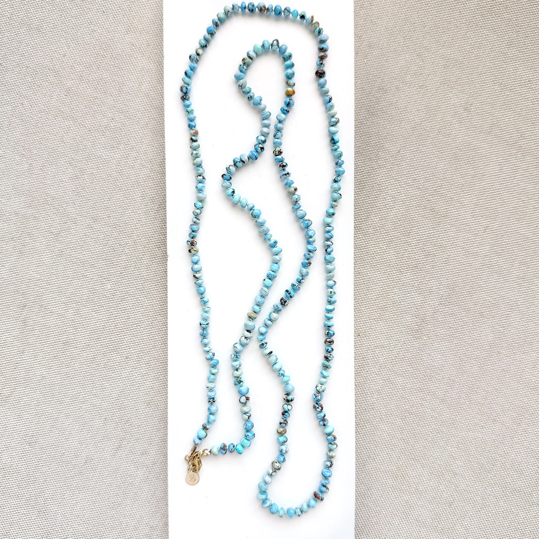 Golden Hills turquoise beaded necklace on a white dish with a neutral background
