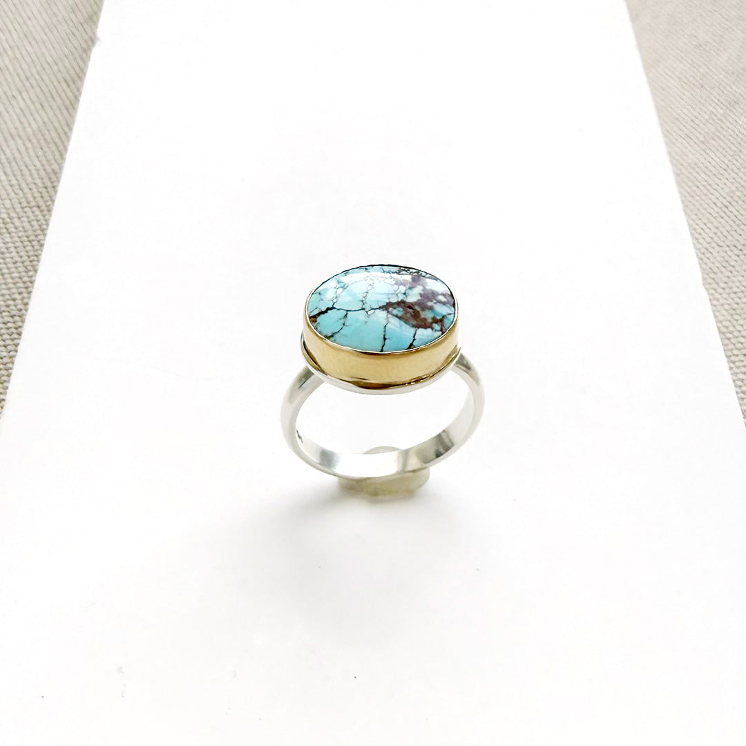 One of a kind Golden Hills turquoise mixed metal ring on a white background