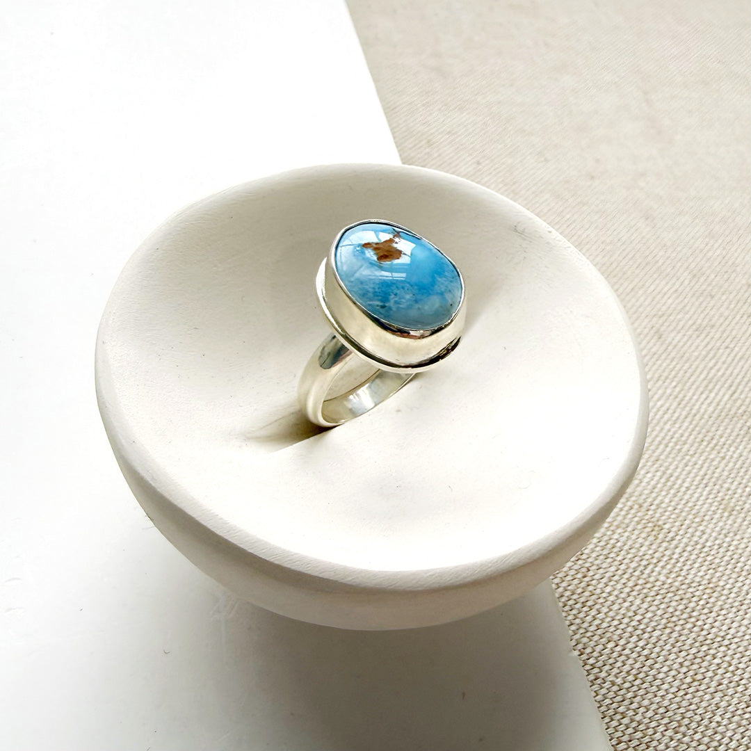 One of a kind Golden Hills Turquoise silver ring in a white dish
