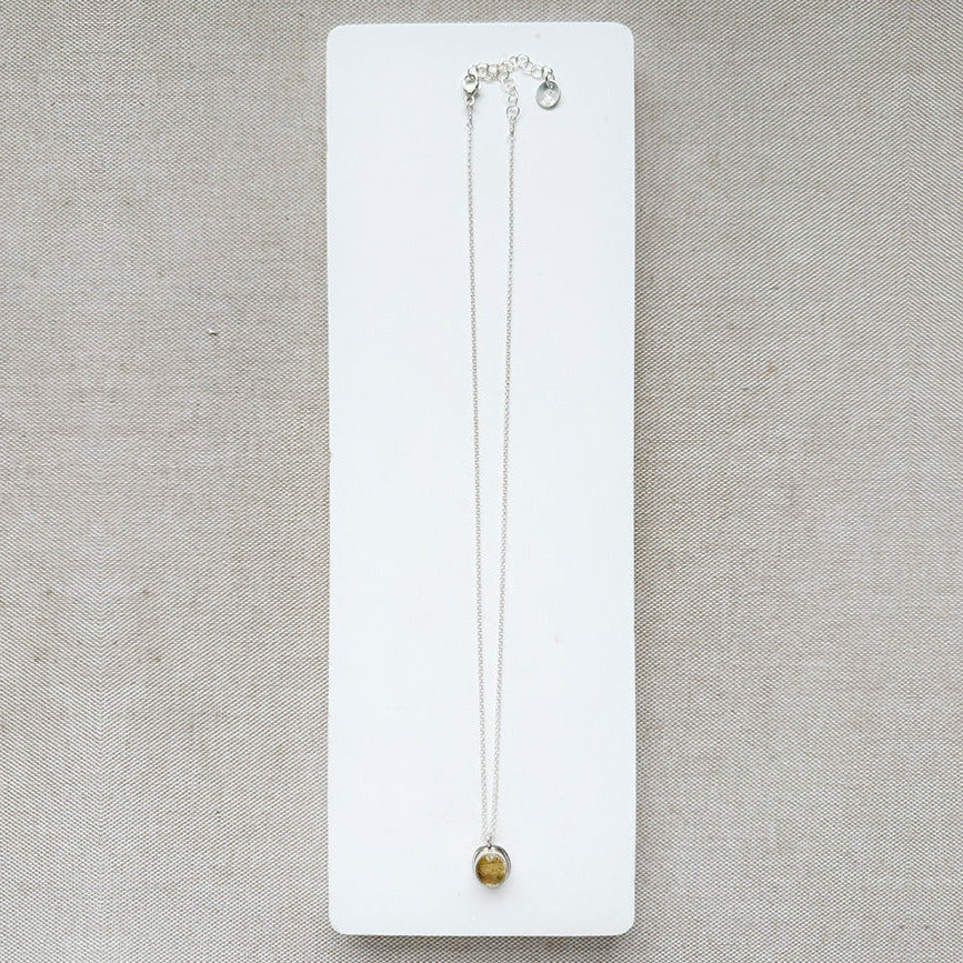 Silver gemstone pendant with carved scarab details