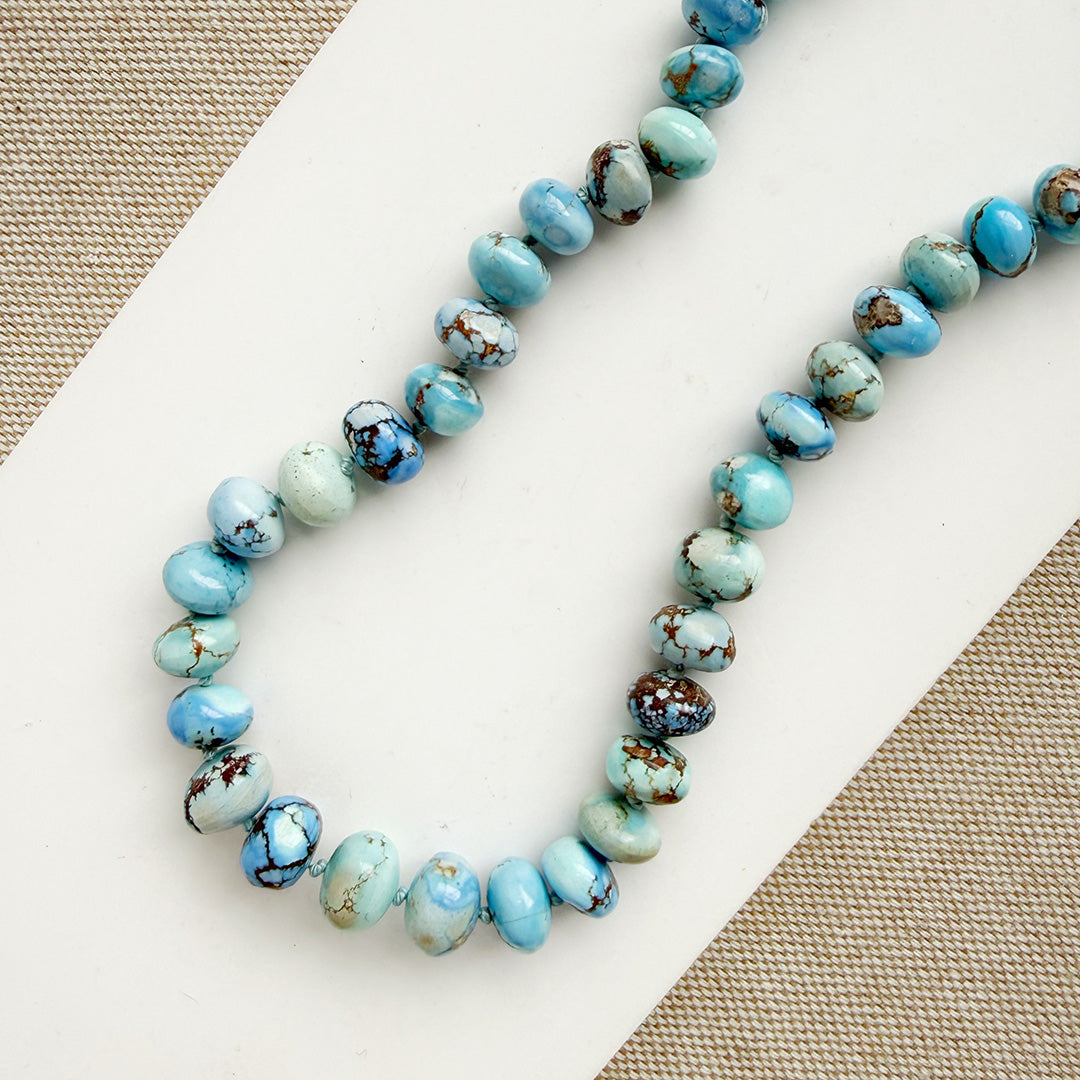 Golden Hills Turquoise knotted necklace on a white plate