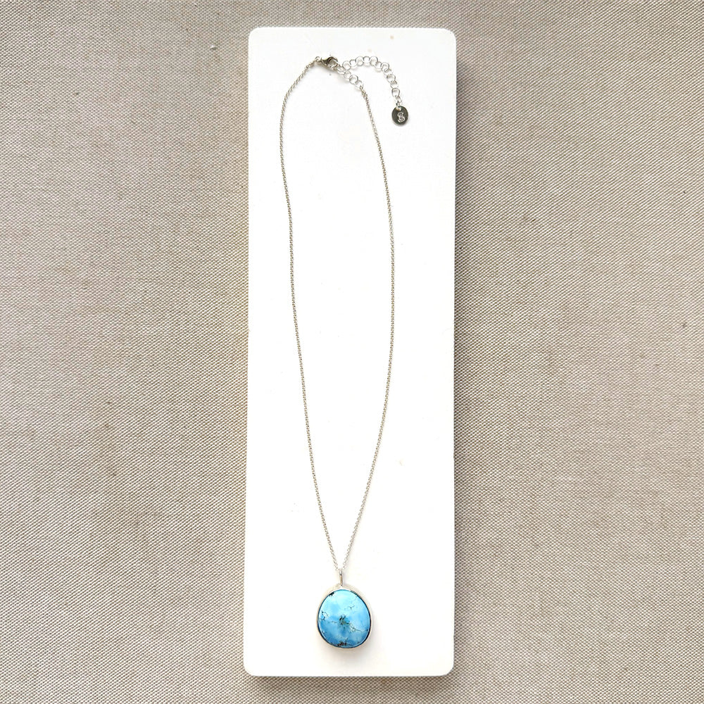 Golden Hills Pendant set in sterling silver on a white dish