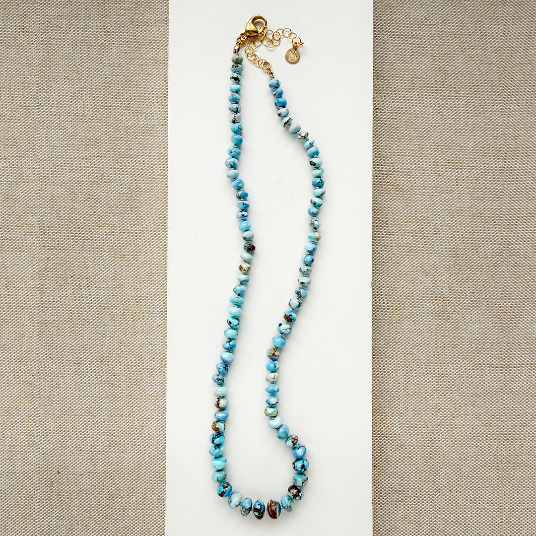 Golden Hills Turquoise knotted necklace on a white plate