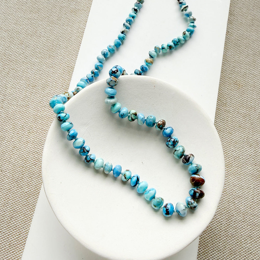 Golden Hills Turquoise knotted necklace in a white dish