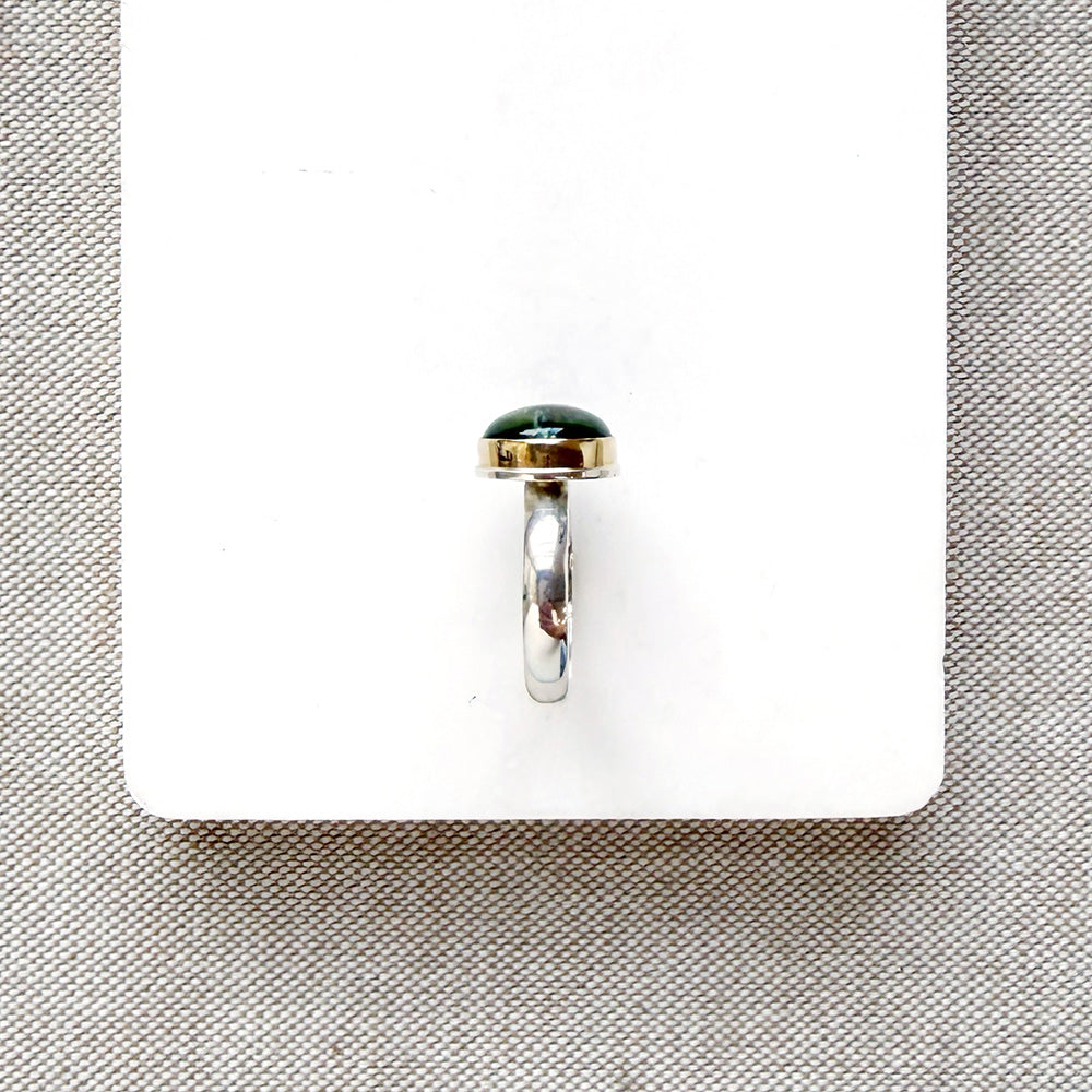 Green Tourmaline mixed metal ring on a white background