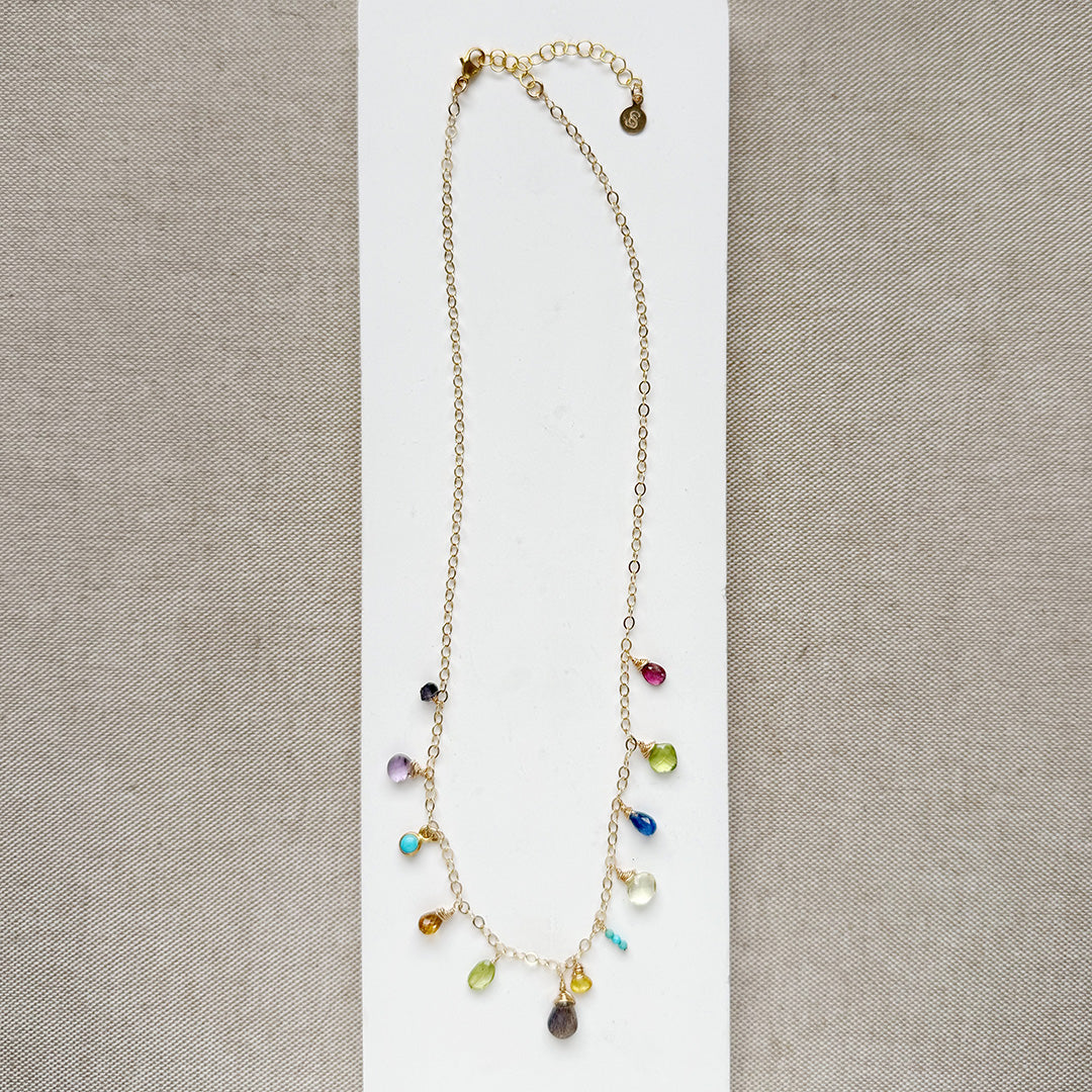 Multicolored gemstone necklace on a white background
