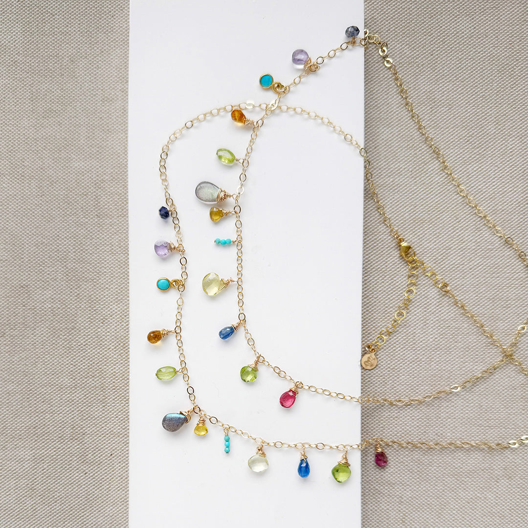 Multicolored gemstone necklace on a white background