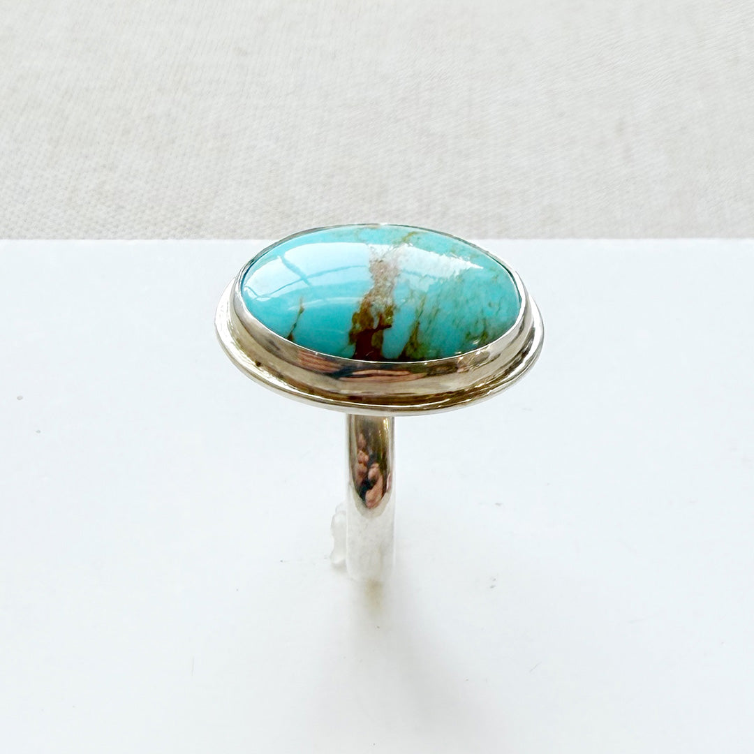 Turquoise ring with silver band on a white background