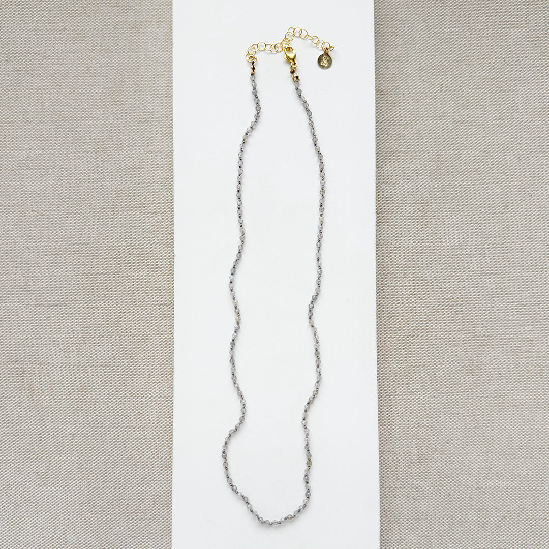 Necklace with small labradorite gemstones on a white background