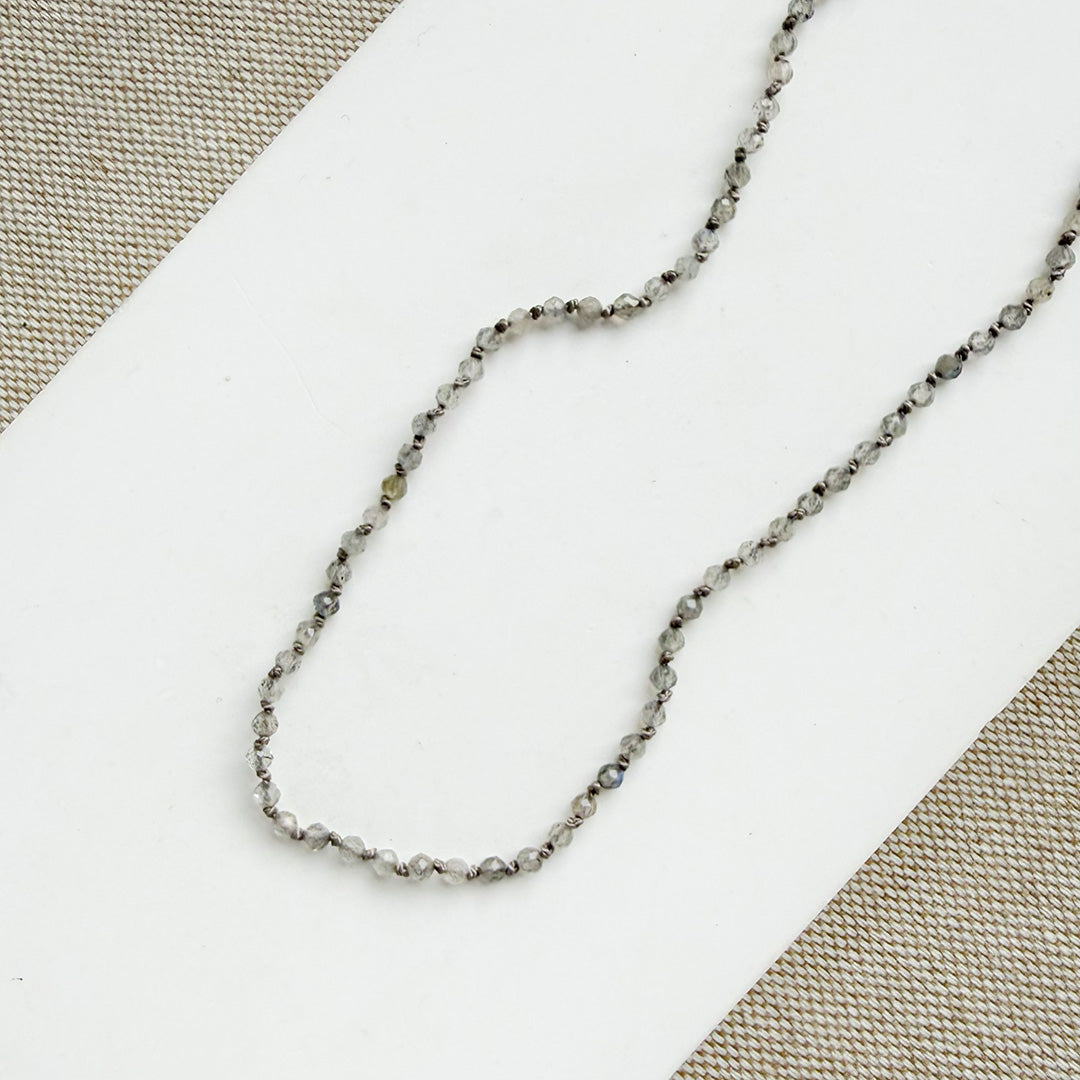 Necklace with small labradorite gemstones on a white background