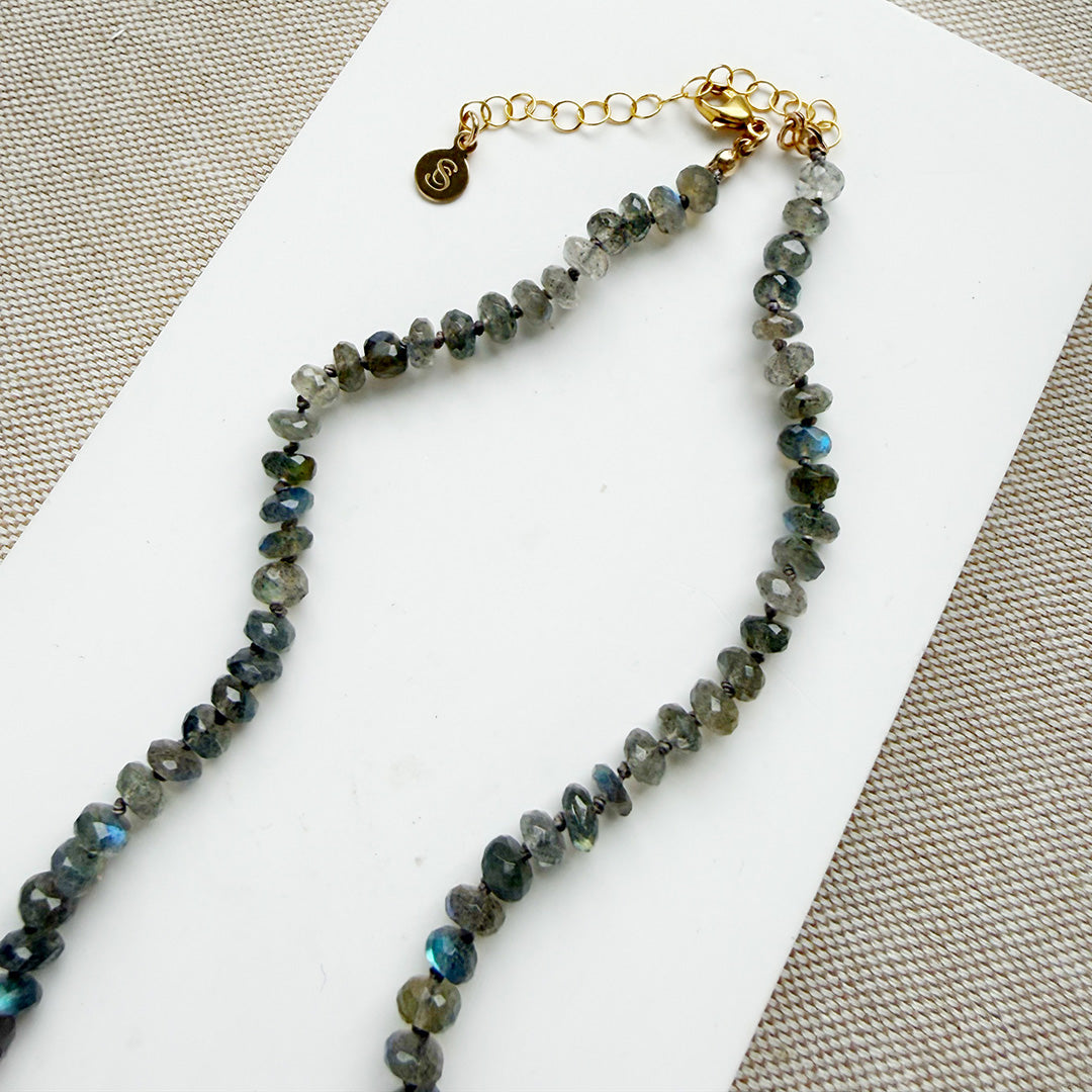 Clasp detail of knotted labradorite necklace with flower shaped carved mother of pearl pendant