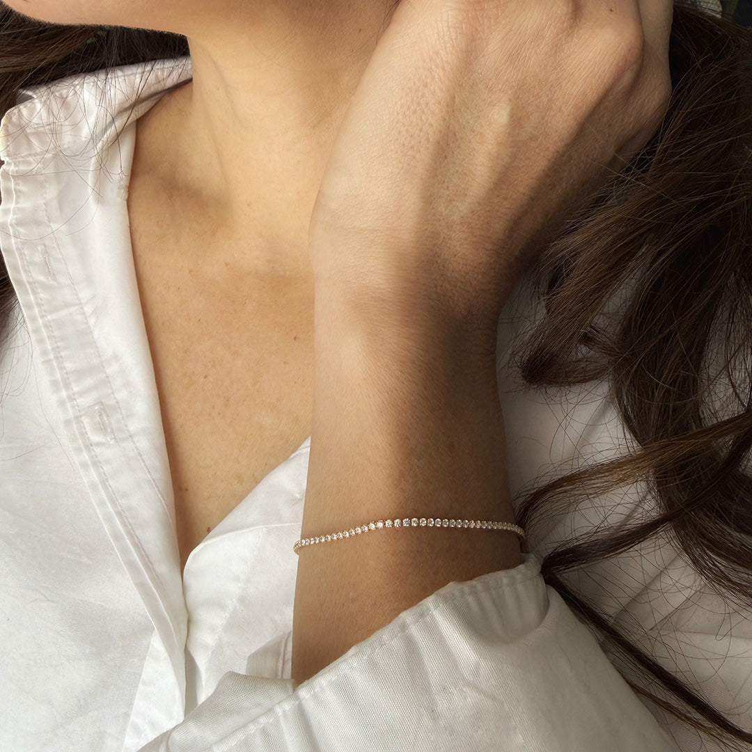 Close up of woman's wrist wearing micro style CZ tennis bracelet