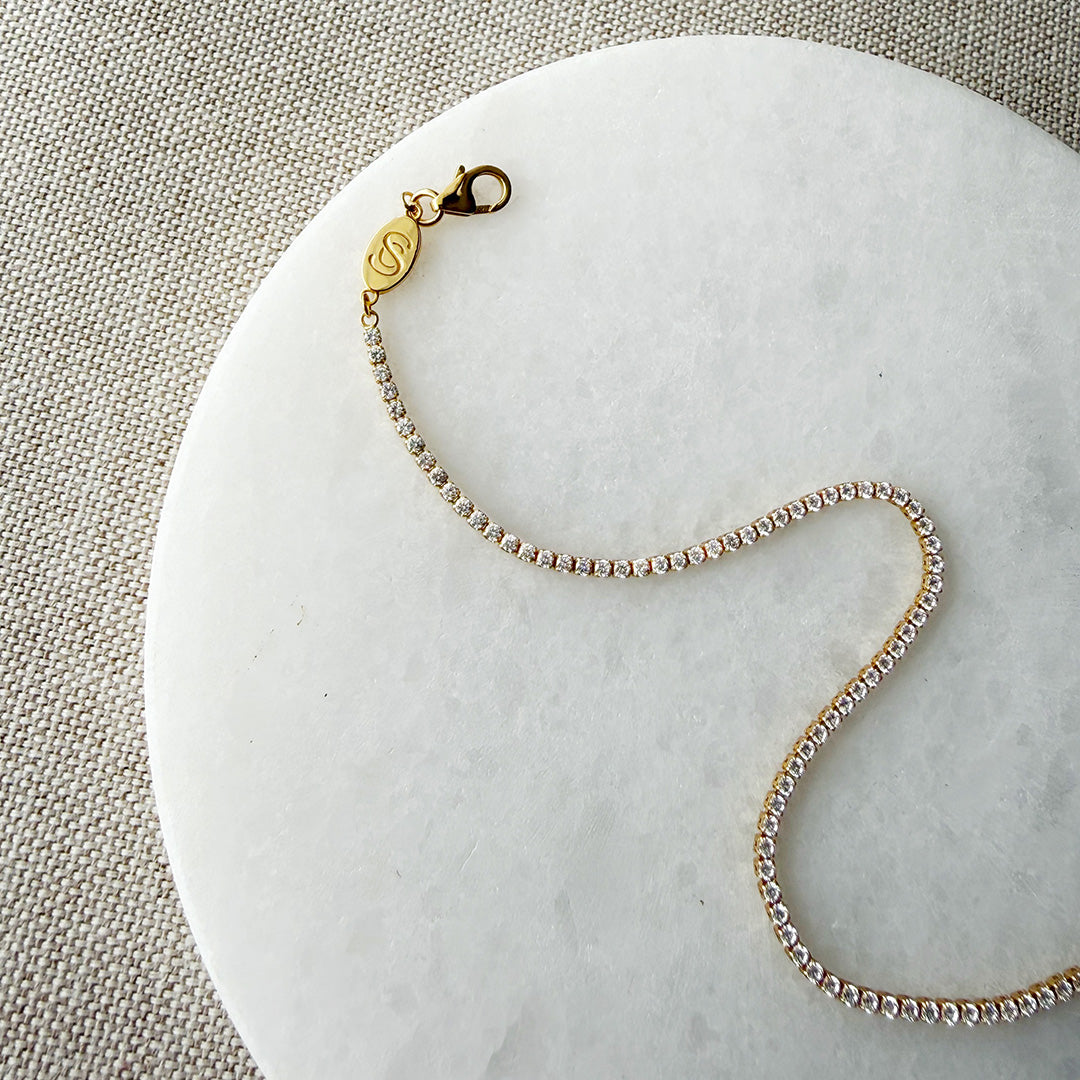 Clasp detail on a gold and CZ micro style tennis bracelet