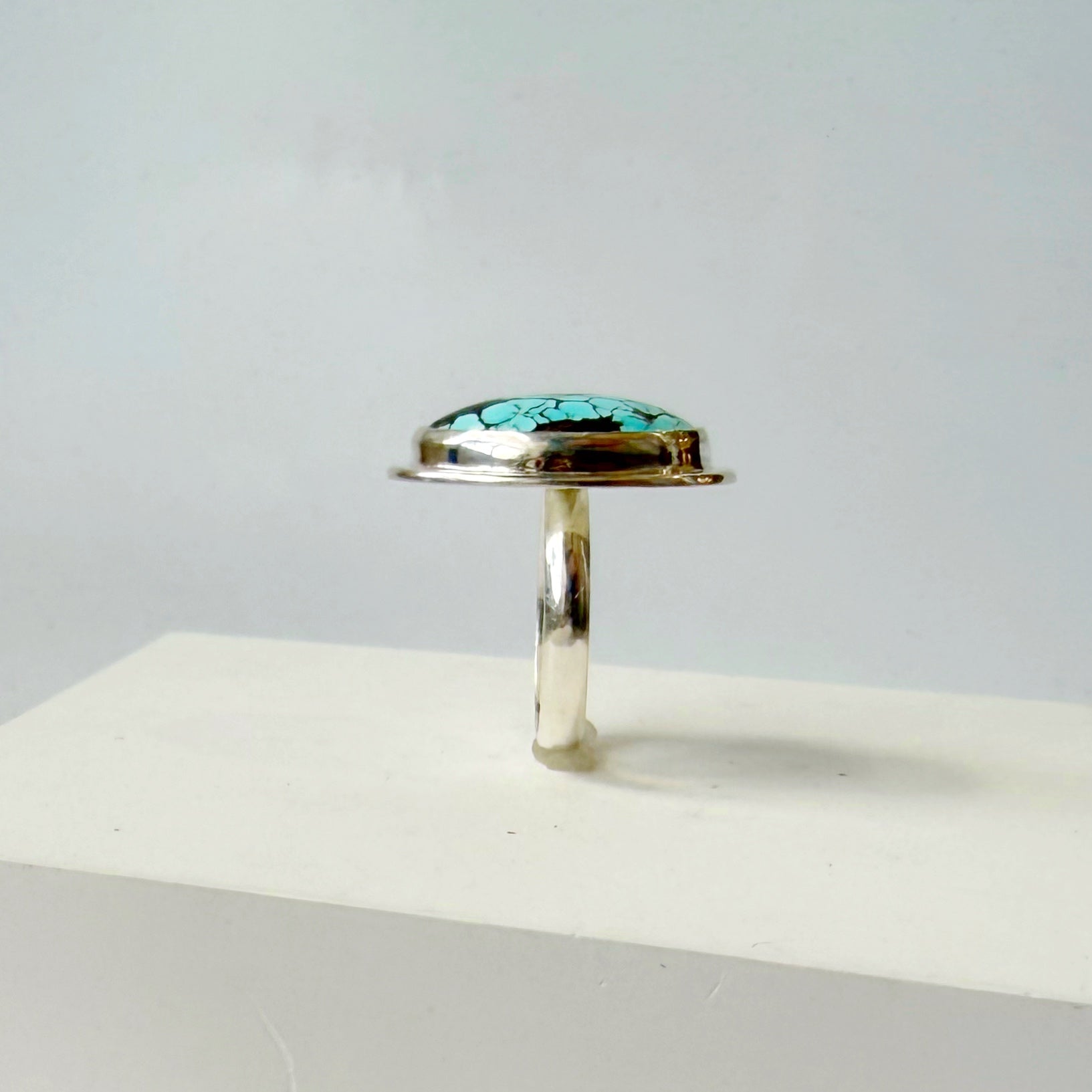 Side view of Nevada turquoise ring on a white background