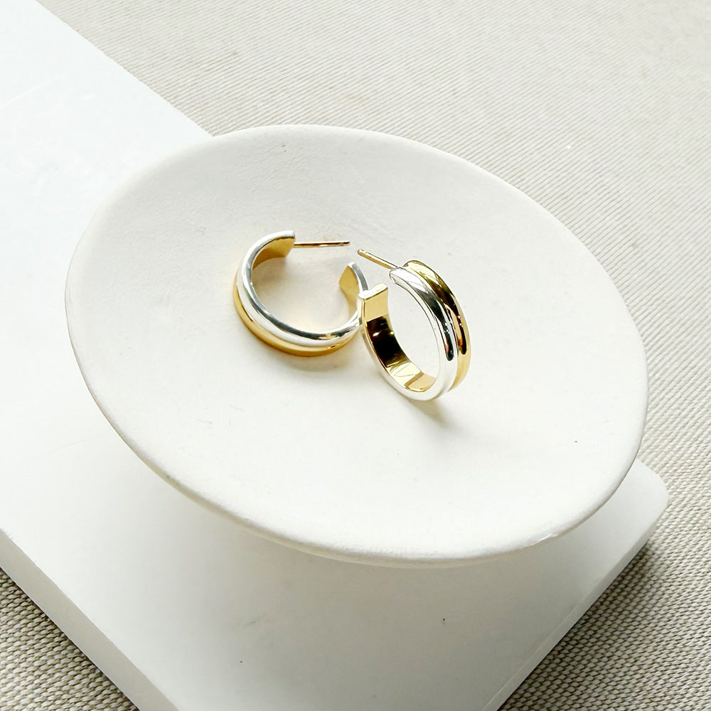 Mixed Metal hoop in a white dish on a light colored background