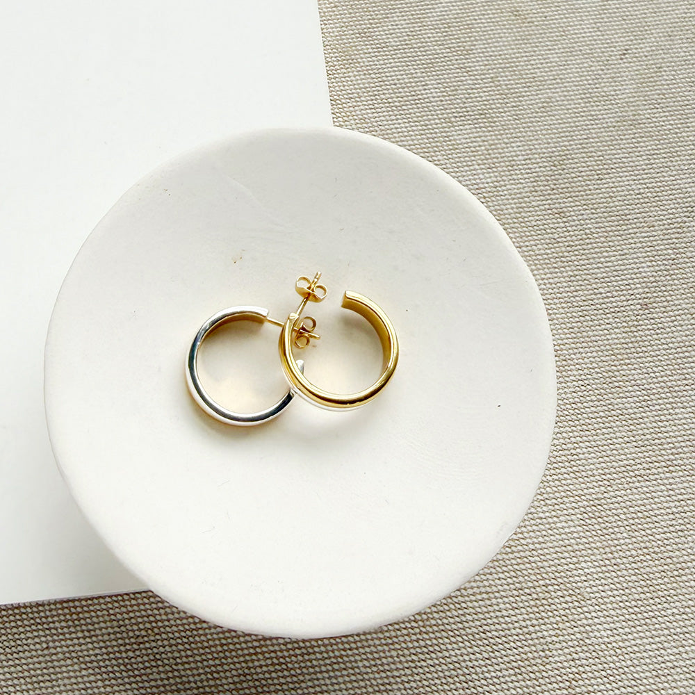 Mixed Metal hoop in a white dish on a light colored background