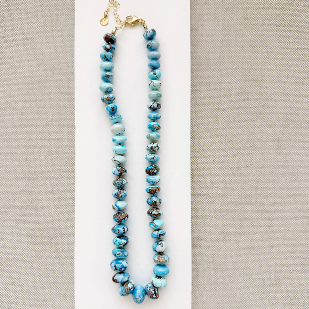 Golden Hill turquoise beaded necklace on a white dish with a neutral background