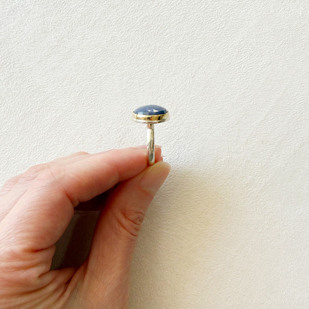 Side view of a round faceted sapphire ring