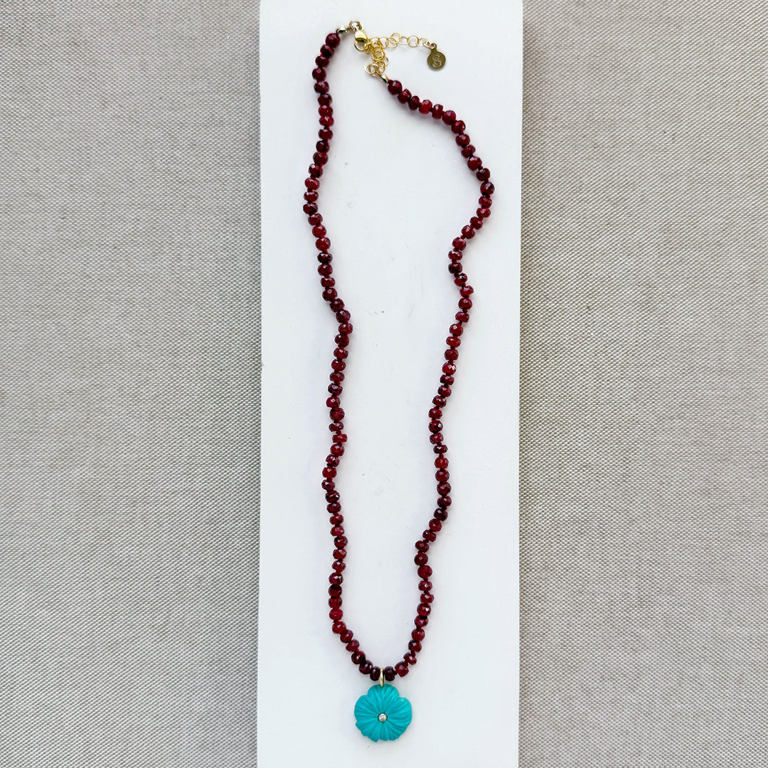 Ruby knotted necklace with turquoise carved flower pendant