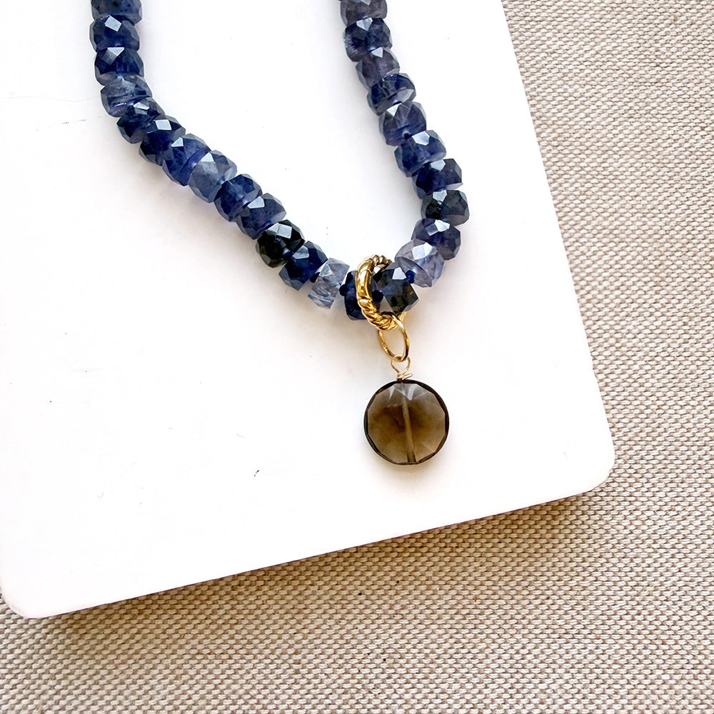 Round smoky quartz charm on a gemstone necklace