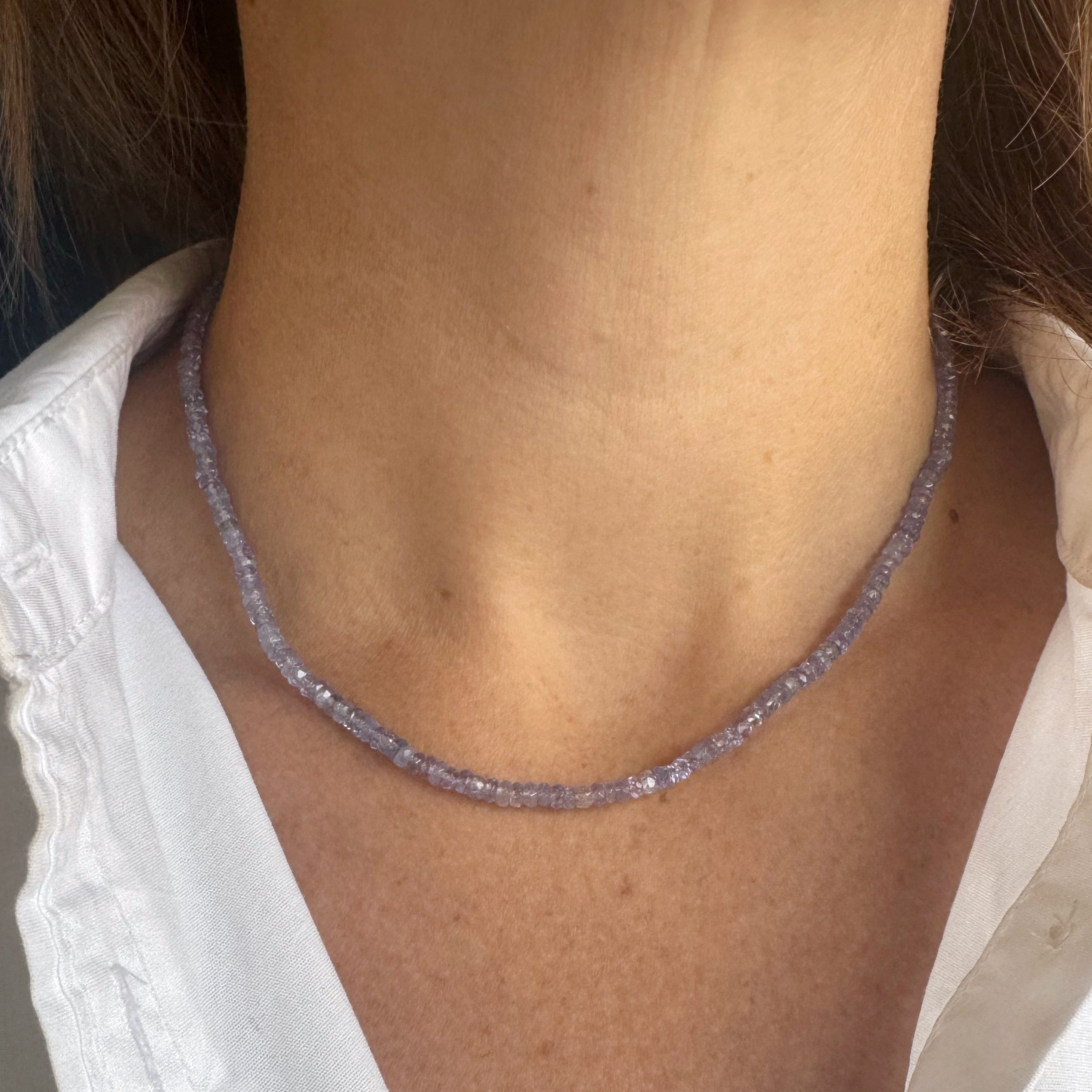 Necklace worn by a person with a white shirt
