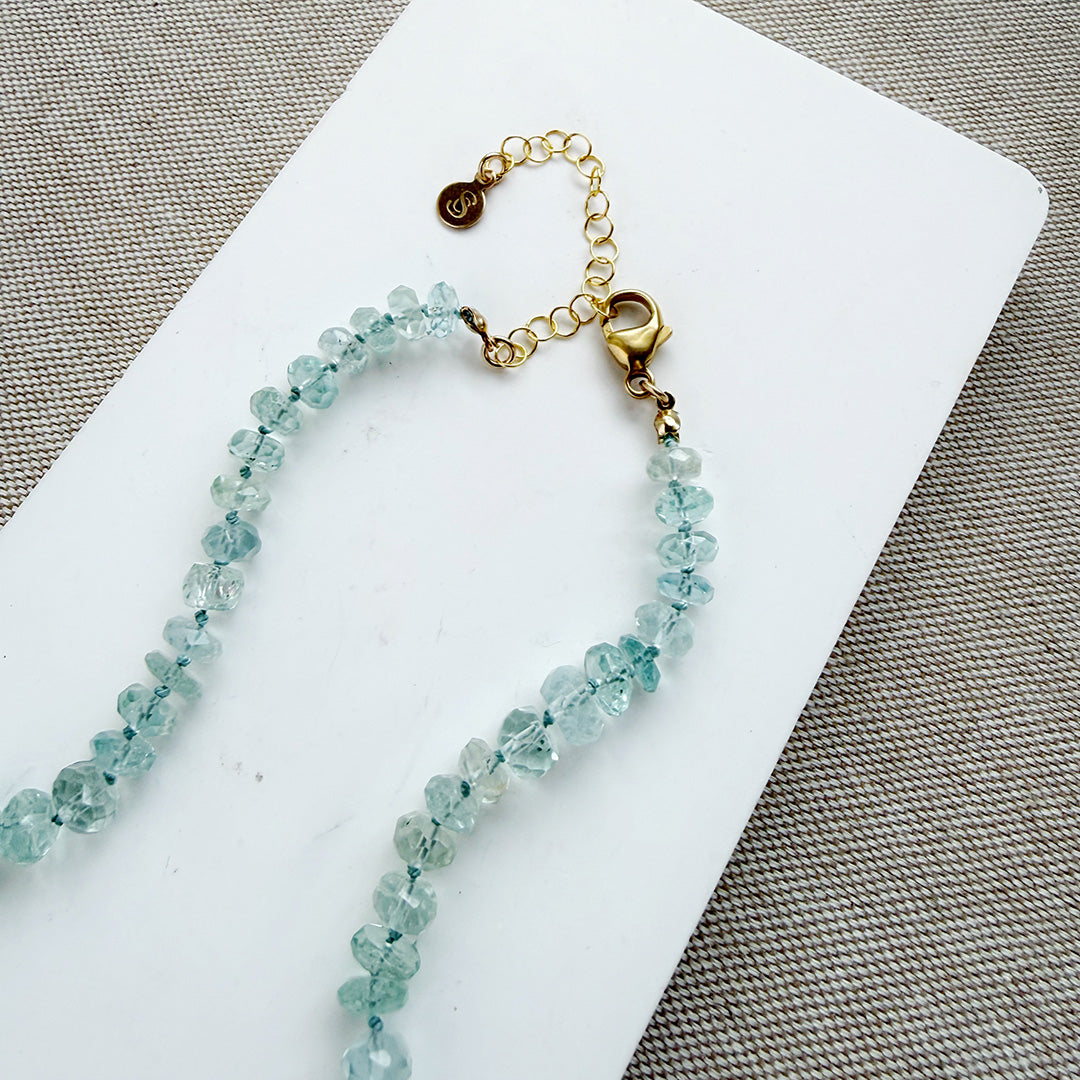 Clasp detail of knotted blue topaz necklace