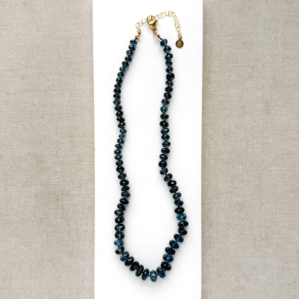 London Blue knotted necklace on a white dish