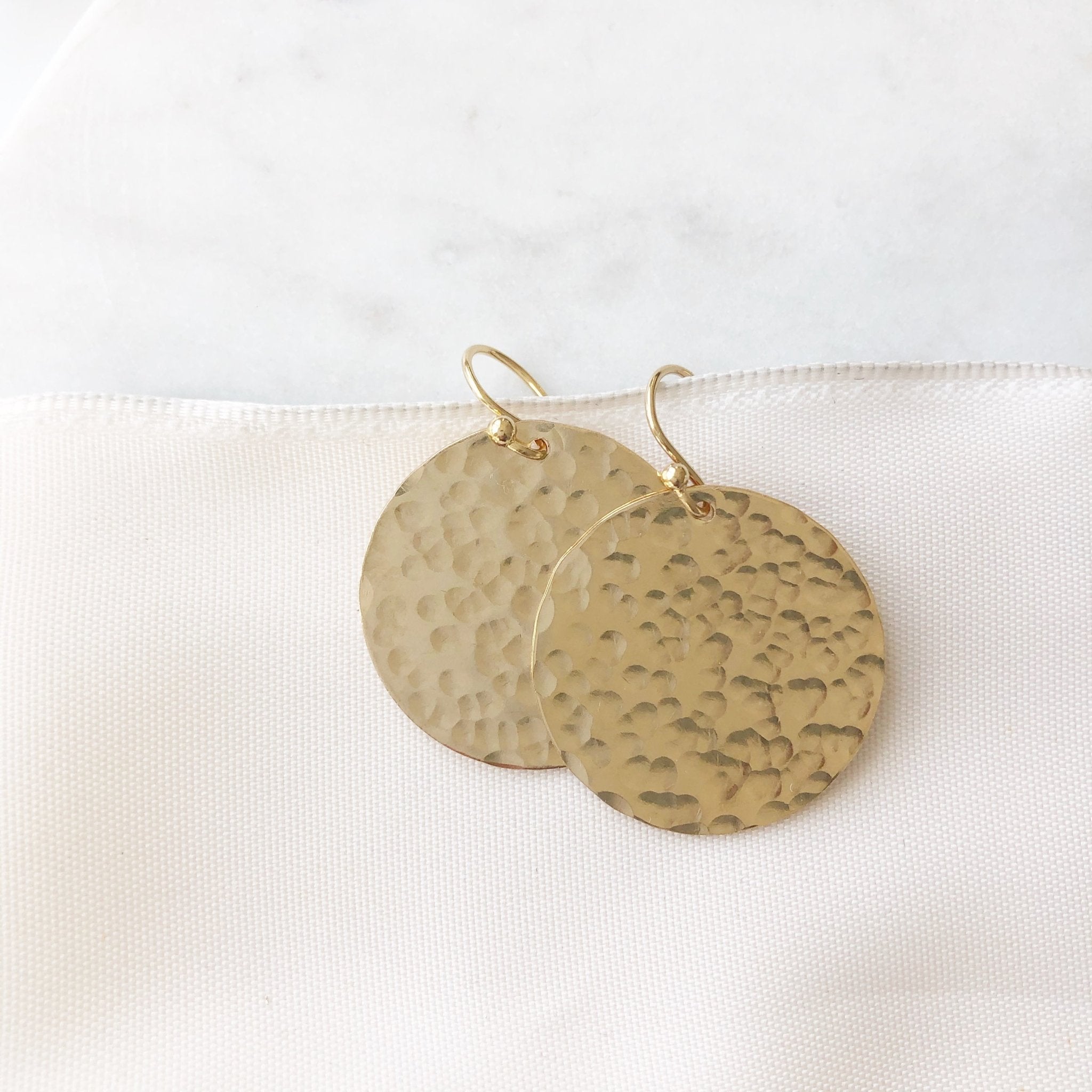 Gold Buffay Earrings by Sarah Cornwell Jewelry.  Lightweight, shimmery, textured 1 inch gold disc earrings on a white background.