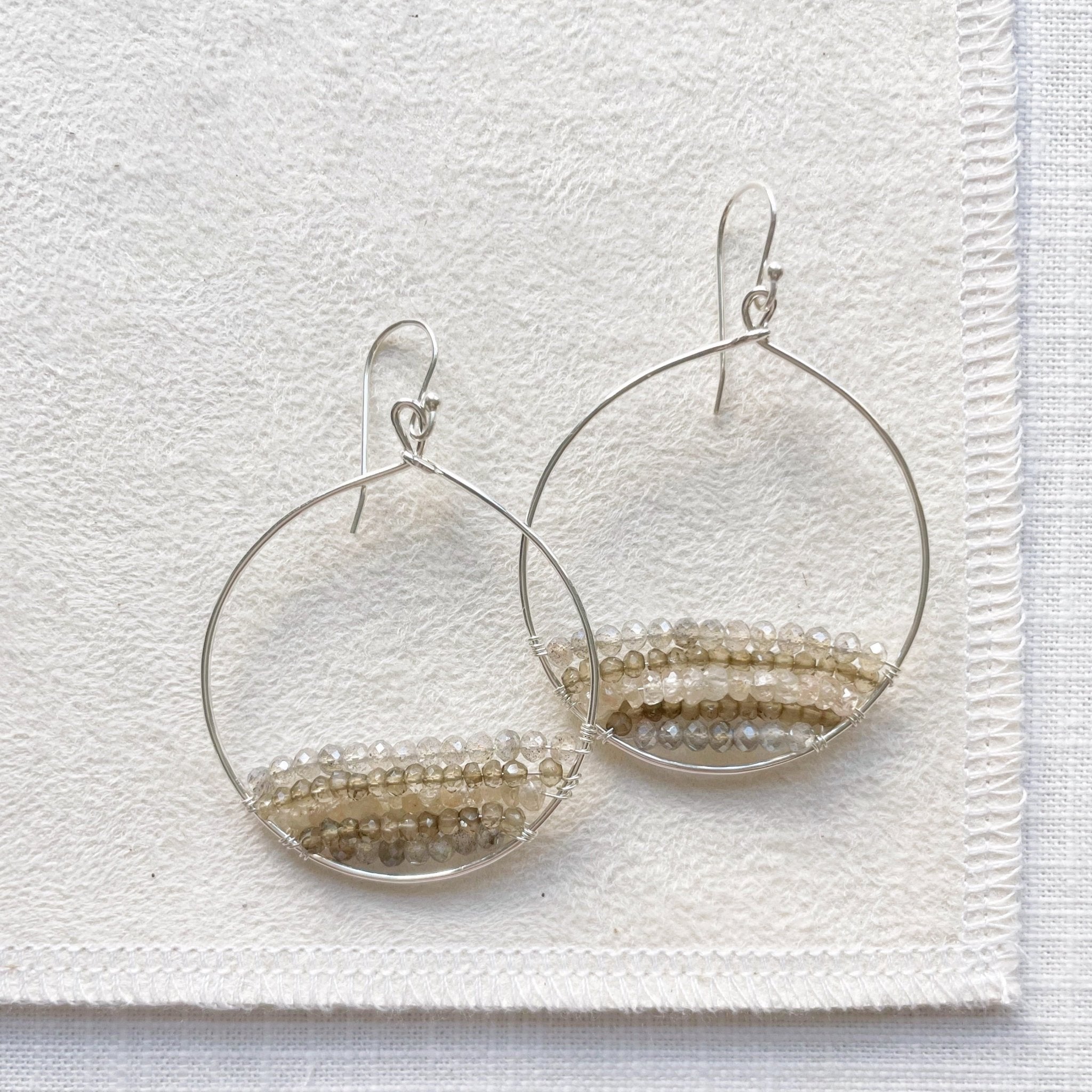 Silver and gemstone statement 2 inch hoop earrings with rows of zircon, labradorite, and smokey topaz gemstones. Harper Earrings by Sarah Cornwell Jewelry