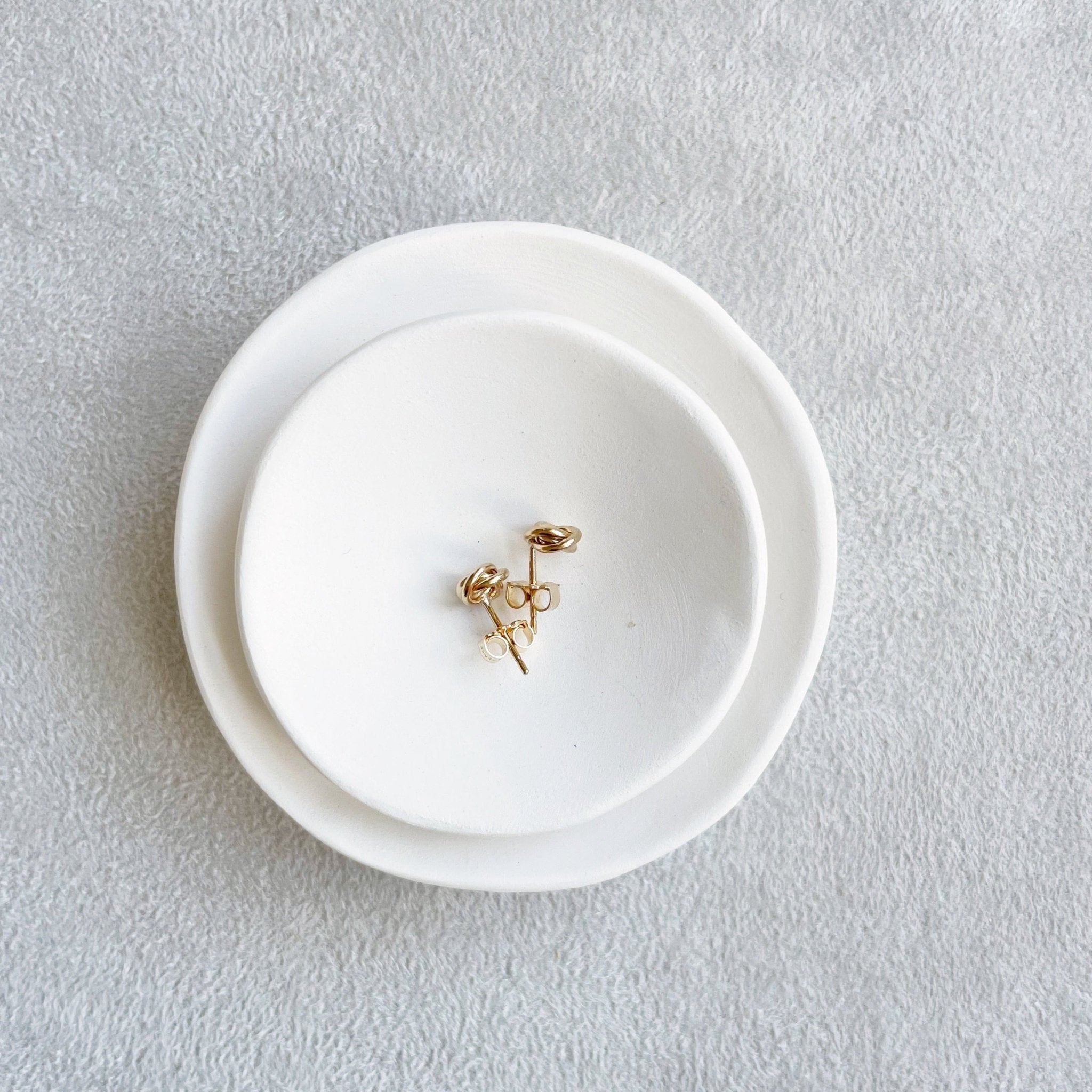 Side view of 6 mm gold love knot stud earrings. Love Knot Studs by Sarah Cornwell Jewelry