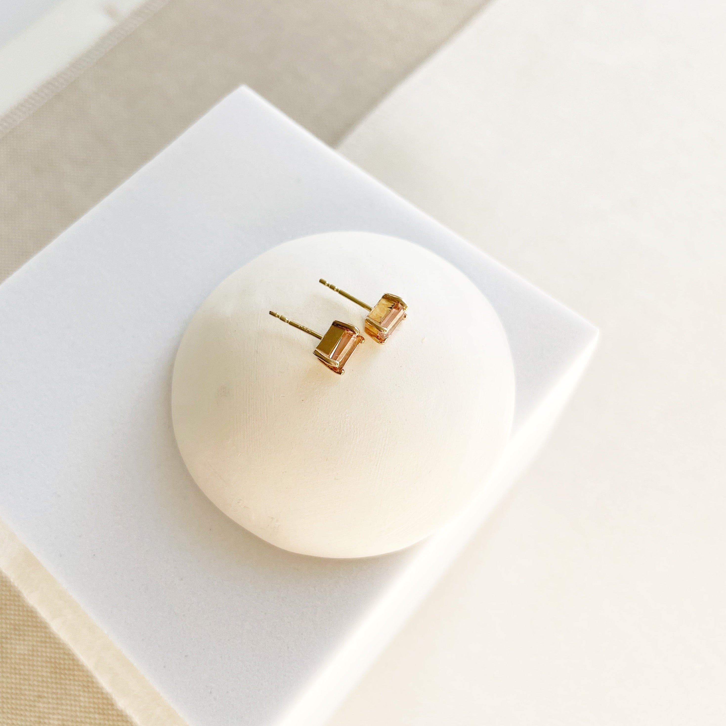 Side view of 14K gold and 1 carat rectangular cut peach pink tourmaline stud earrings. Michelle Studs by Sarah Cornwell Jewelry