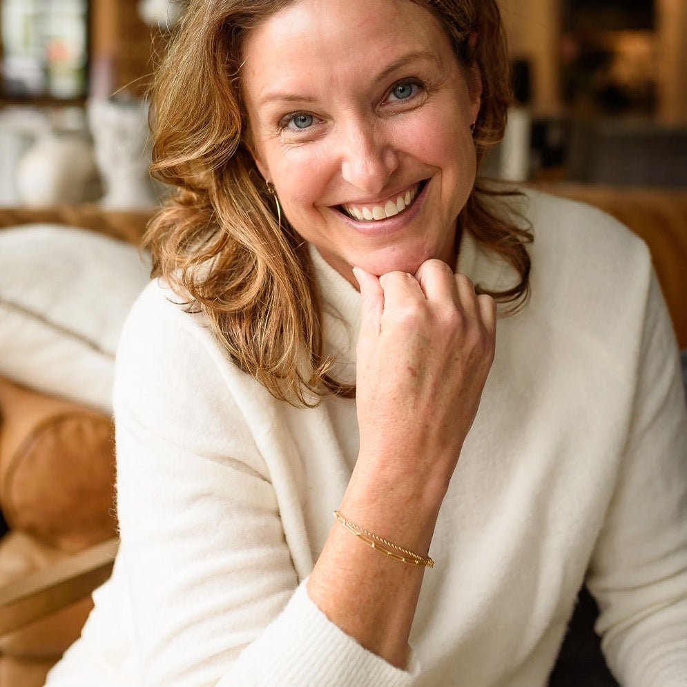 Woman wearing white sweater with gold large link chain bracelet, gold chain bracelet and gold hoop earrings. Sunny Bracelet by Sarah Cornwell Jewelry