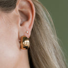 Close up of chunky gold hoop earring