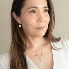 Woman wearing small gold disc earring
