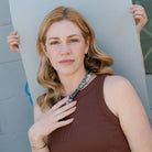 Woman in brown tank wearing a statement agate necklace