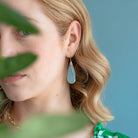 Woman wearing a green floral dress with a blurred background