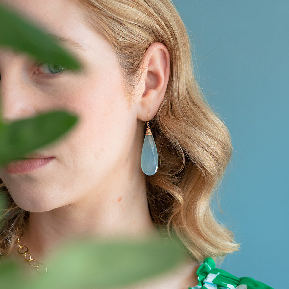 Woman wearing a green floral dress with a blurred background