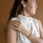 Woman wearing green tourmaline ring