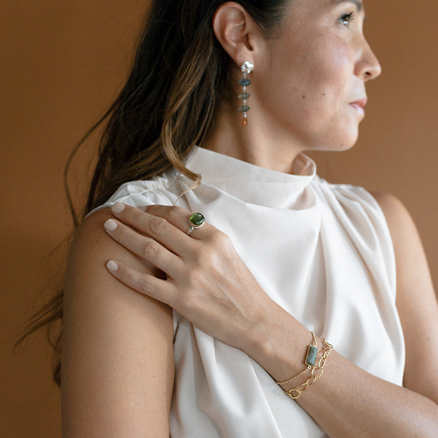 Woman wearing green tourmaline ring