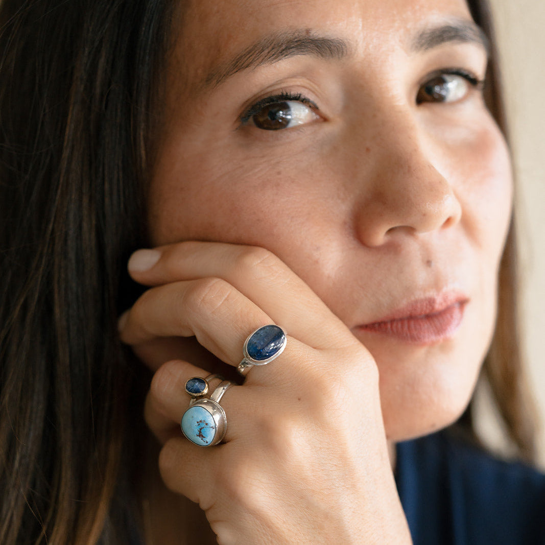 Woman wearing one of a kind gemstones rings