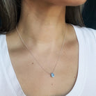 Close up of woman wearing tear drop shaped Golden Hills Turquoise necklace